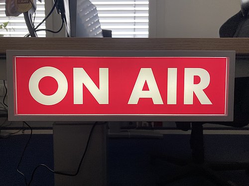 Ein leuchtendes Schild, dass den Text "ON AIR" zeigt Image Lightbox